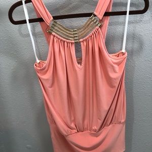 Pink blouse with a gold statement jewel